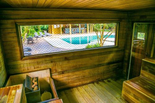 a view from the inside of a cabin with a window at Banana Bamboo Ecolodge in Ubatuba
