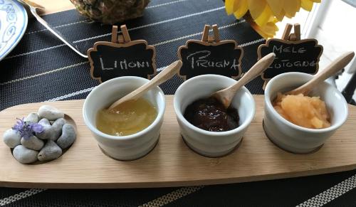 a tray with three bowls of dipping sauce and cookies at Relais Masseria della Colomba - Agriturismo in Francavilla Fontana
