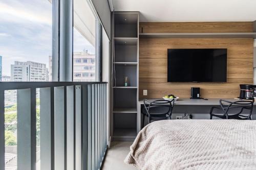 a bedroom with a bed and a tv on a wall at GO 24 by My Way in Porto Alegre