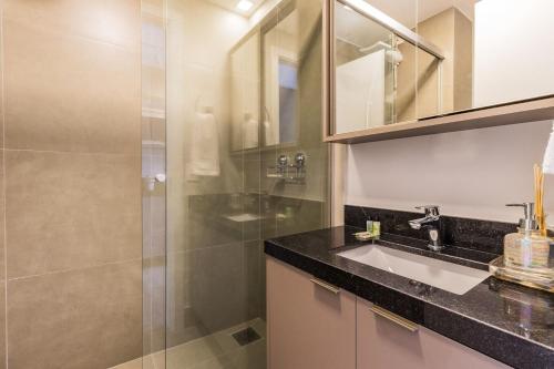 a bathroom with a sink and a shower at GO 24 by My Way in Porto Alegre