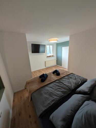 a bedroom with a large bed and a flat screen tv at Villa Baumhaus Apartments in Hamm