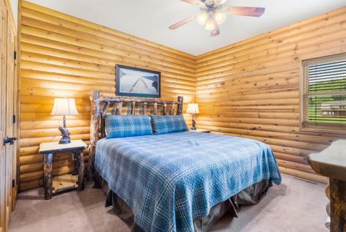 a bedroom with wooden walls and a bed in a room at Luxury Lakefront Chalet Resort 2 Pools FREE Amenities Dock MiniGolf Waterslide in Lampe