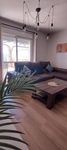 a living room with a couch and a table at Mi casa en Almogia - Andalucia in Almogía