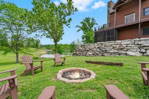 a yard with two benches and a fire pit at Luxury Lakefront Chalet Resort 2 Pools FREE Amenities Dock MiniGolf Waterslide in Lampe