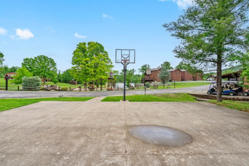 a basketball hoop in the middle of a park at Luxury Lakefront Chalet Resort 2 Pools FREE Amenities Dock MiniGolf Waterslide in Lampe