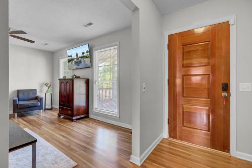 an empty living room with a wooden door at Charleston, near Airport, luxury and cozy house in Ladson