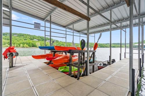 a dock with a table and boats on the water at Luxury Lakefront Chalet Resort 2 Pools FREE Amenities Dock MiniGolf Waterslide in Lampe