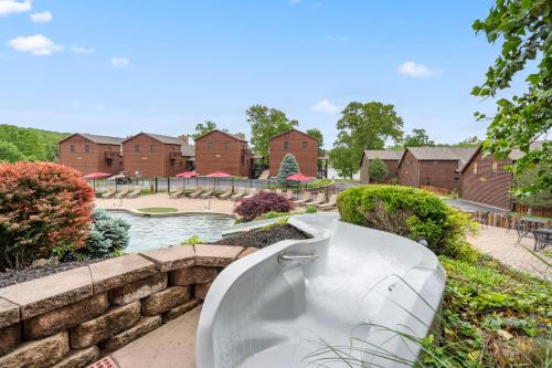 a white bath tub sitting in front of a house at Luxury Lakefront Chalet Resort 2 Pools FREE Amenities Dock MiniGolf Waterslide in Lampe
