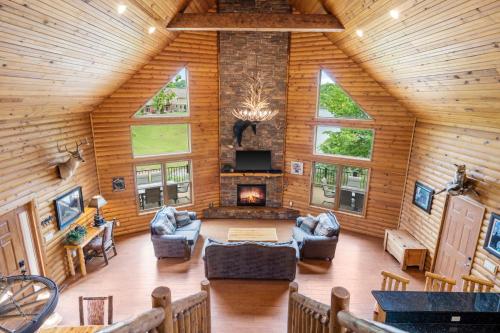 a living room with a fireplace in a log cabin at Luxury Lakefront Chalet Resort 2 Pools FREE Amenities Dock Kayaks Waterslide in Lampe