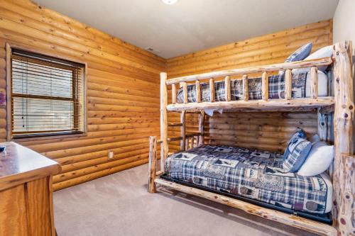 a bedroom with two bunk beds in a log cabin at Luxury Lakefront Chalet Resort 2 Pools FREE Amenities Dock Kayaks Waterslide in Lampe