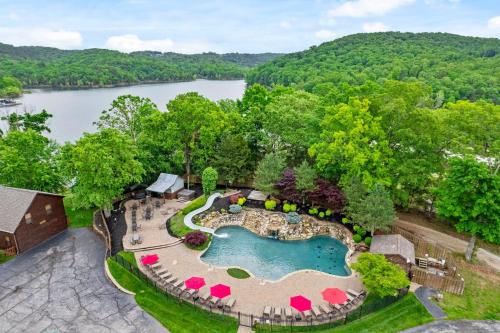 an overhead view of a pool with a resort and a lake at Luxury Lakefront Chalet Resort 2 Pools FREE Amenities Dock Kayaks Waterslide in Lampe