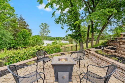 a patio with chairs and a table and a fire place at 8 Bed Luxury Lakefront Villa Amazing View 2 Pools Free Resort Amenities Dock in Lampe