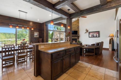 an open kitchen and dining room with a large island at Chalets Resort Luxury Lakefront Villa Amazing View 2 Pools Free Amenities Dock in Lampe
