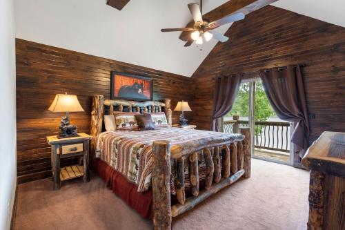 a bedroom with a bed with a wooden wall at Chalets Resort Luxury Lakefront Villa Amazing View 2 Pools Free Amenities Dock in Lampe