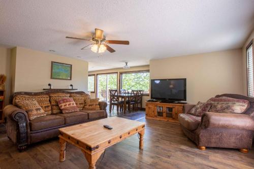 a living room with two couches and a tv at Chalets Resort LAKEFRONT Cottage Free Amenities Amazing views Kayaks 2 Pools in Lampe
