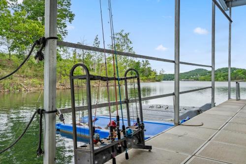 a swing set on a boat on a river at Chalets Resort Luxury Lakefront Villa Amazing View 2 Pools Free Amenities Dock in Lampe