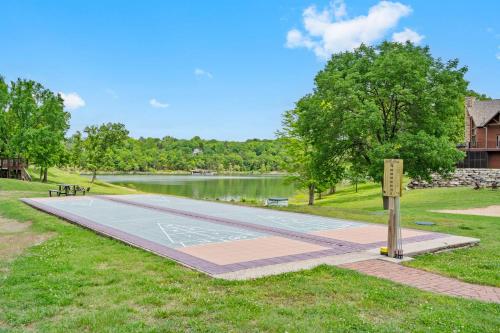 a park with a boardwalk next to a lake at Chalets Resort LAKEFRONT Cottage Free Amenities Amazing views Kayaks 2 Pools in Lampe
