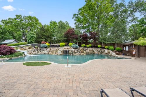 a swimming pool with a waterfall in a yard at Chalets Resort LAKEFRONT Cottage Free Amenities Amazing views Kayaks 2 Pools in Lampe