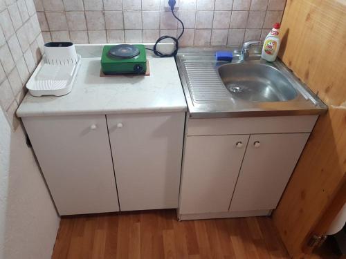 a small kitchen with a sink and a scale at Ozon in Belgrade