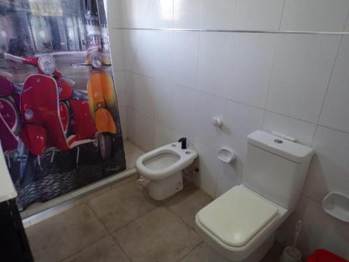a bathroom with a toilet and a sink and a toilet at Cuesta de san miguel in Chilecito