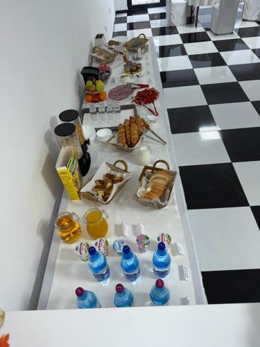 a long table with food on it in a room at Hotel Oaza in Kikinda