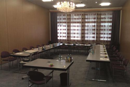 a dining room with tables and chairs and a chandelier at Hotel Empfinger Hof, Sure Hotel Collection by Best Western in Empfingen