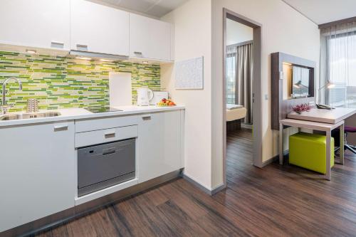 an open kitchen with a sink and a desk at Best Western Hotel Airport Frankfurt in Frankfurt/Main