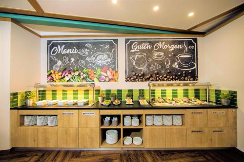 a bakery with a chalkboard on the wall at Best Western Parkhotel Brehna-Halle in Brehna