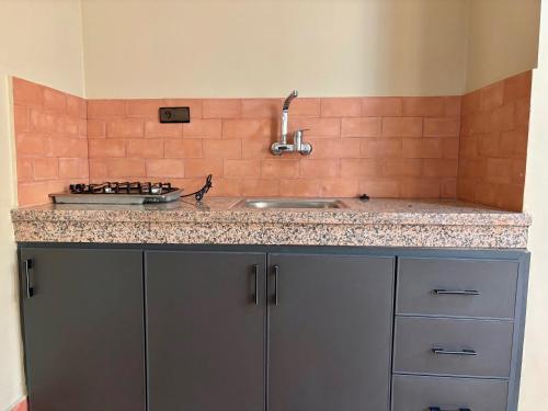 a kitchen with a sink and a counter top at Complexe Kariat Ayoub in Aït Zat