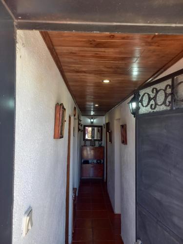 a hallway of a house with a wooden ceiling at Casa Serrana in Penhas da Saúde