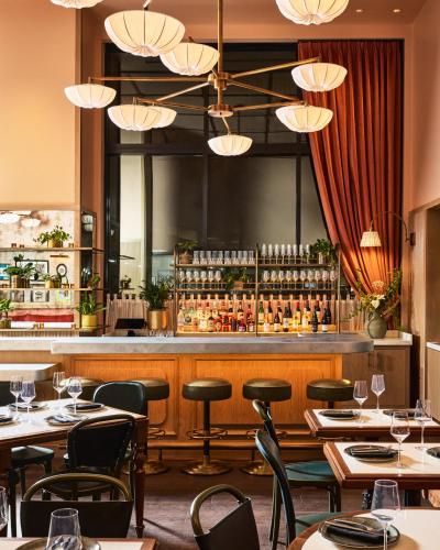 a restaurant with tables and chairs and a bar at Fidelity Hotel in Cleveland