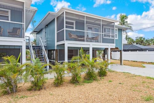 a house with palm trees in front of it at Beach Bungalow 2 by Sun Palace Vacations in Fort Myers Beach