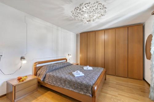 a bedroom with a bed and a chandelier at Villa Anita - Happy Rentals in Caslano