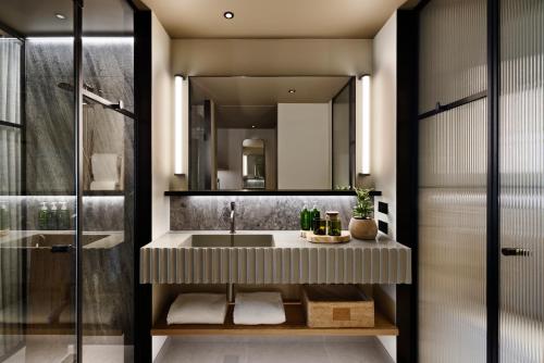 a bathroom with a sink and a mirror at 1 Hotel Melbourne in Melbourne