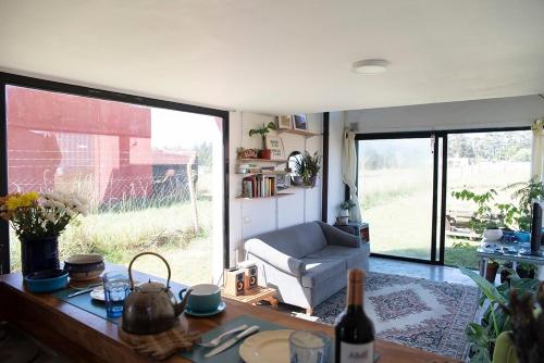 a living room with a couch and a table at Casa de Playa Los Lobos Chapa in La Estafeta