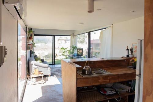 a kitchen with a counter and a living room at Casa de Playa Los Lobos Chapa in La Estafeta