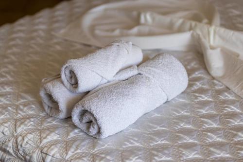 a couple of towels sitting on top of a bed at Apartments Monte in Ulcinj