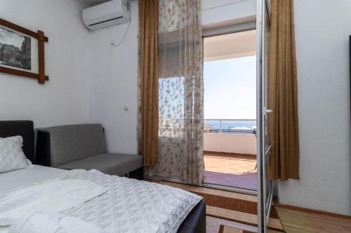 a bedroom with a bed and a window with a view at Apartments Monte in Ulcinj