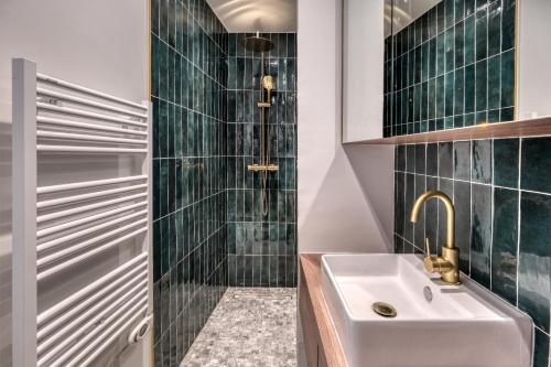 a bathroom with a sink and a shower at Renovated Apartment Saint-Germain-des-Prés - Le Bon Marché in Paris