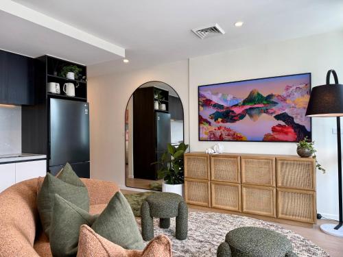 a living room with a large painting on the wall at Heart of South Melbourne with free parking in Melbourne