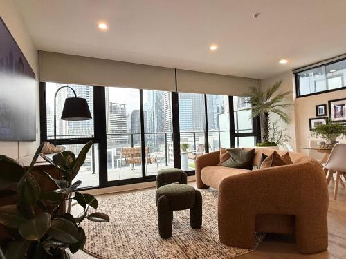 a living room with a couch and a large window at Heart of South Melbourne with free parking in Melbourne