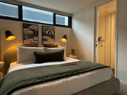 a bedroom with a large bed and a window at Heart of South Melbourne with free parking in Melbourne