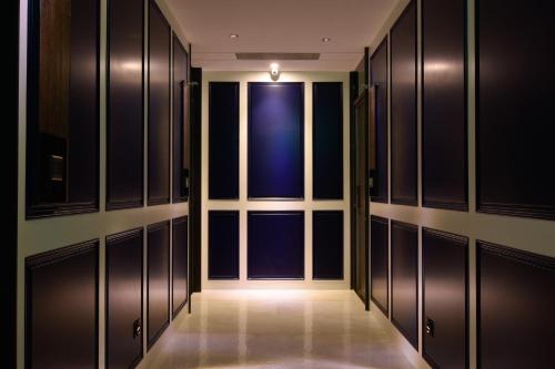 an empty locker room with a door and a window at 3 Door Hotel in Tainan