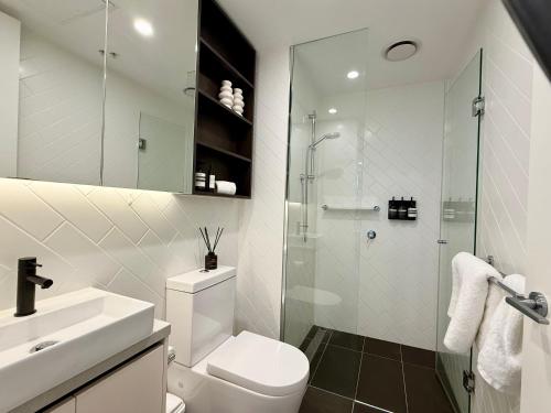 a bathroom with a shower and a toilet and a sink at Heart of South Melbourne with free parking in Melbourne