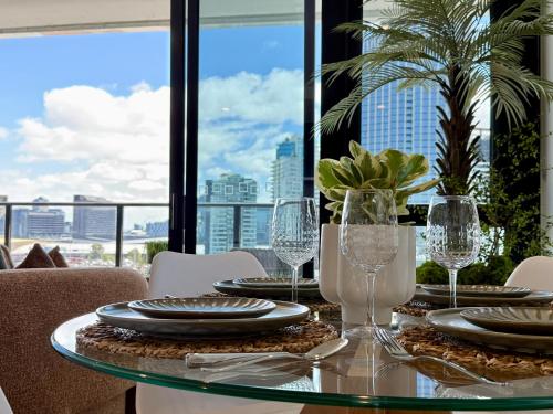 a table with plates and wine glasses on a balcony at Heart of South Melbourne with free parking in Melbourne