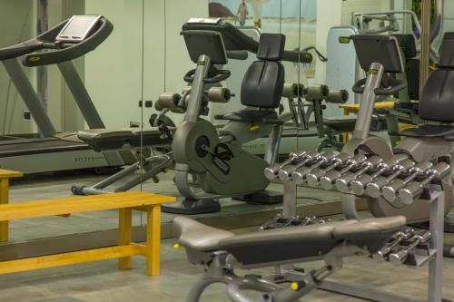a gym with several treadmills and machines at Hotel Futura Centro Congressi in Naples