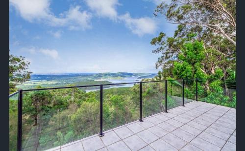 a balcony with a view of the forest at Wren Abode 3 Bedroom A-Frame Home Lower Beechmont with Breakfast Basket in Lower Beechmont