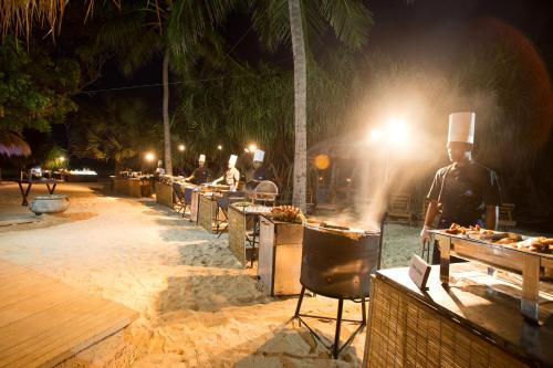 a group of chefs preparing food at night at Nilaveli Beach Hotel in Nilaveli
