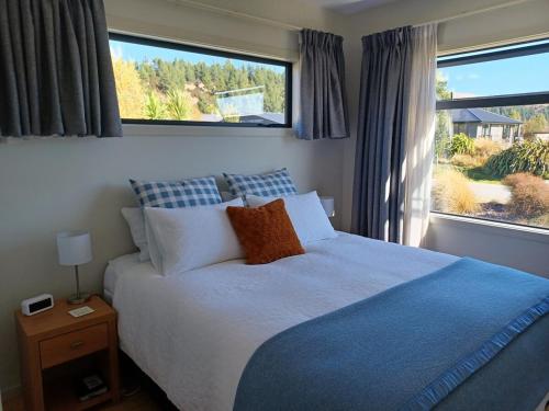 a bedroom with a bed and a large window at Southern Beauty in Luggate