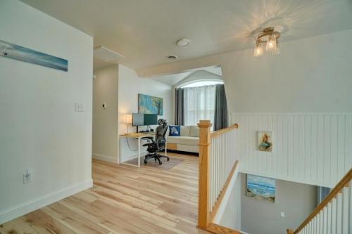 an open living room with a staircase and a desk at Beach Front - Hot Tub - Game Room - 3500SQFT in Cape Charles